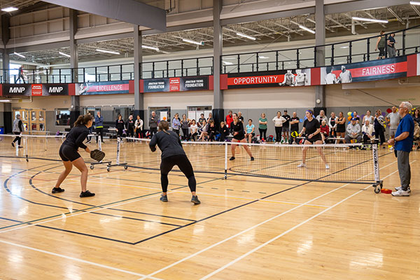 Spring Smash Pickleball Tournament - Dakota Community Centre - Winnipeg MB adults playing pickleball with a group of onlookers