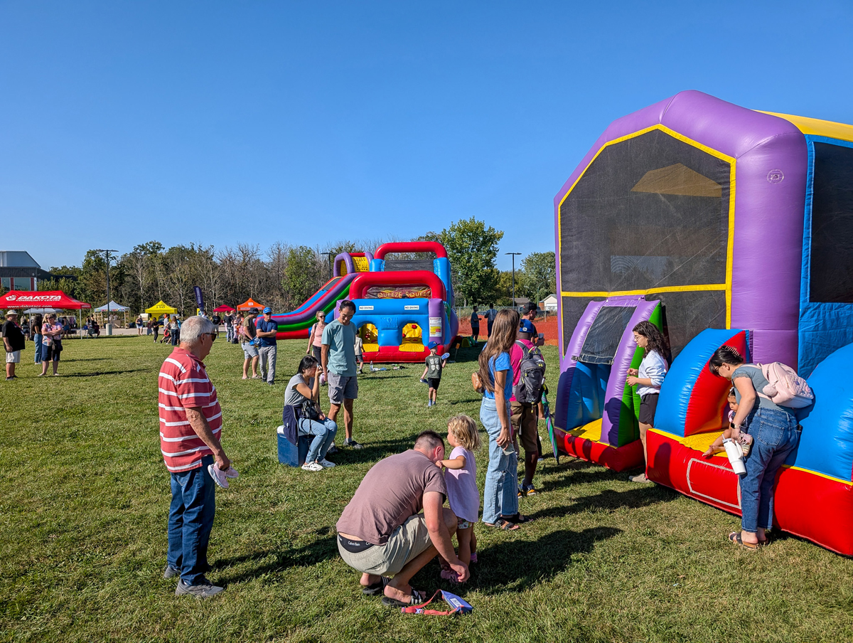 Crowds around the bouncers – Dakota Community Family Fun Days